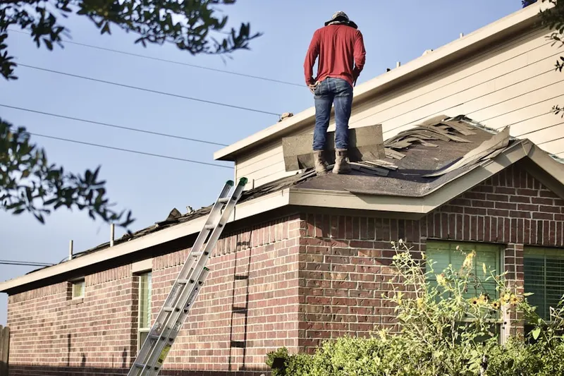 Professional roofer working on a residential roof in Mountainside